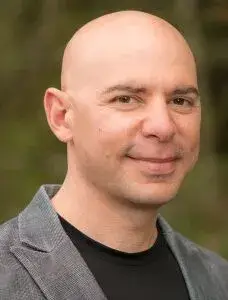 Orthopedist Dr. Thomas Melillo smiling outside on a pleasant afternoon